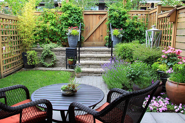 Gardening Ideas For Small Spaces Small townhouse garden with patio furniture amidst blooming lavender.