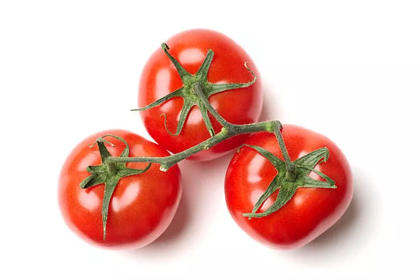 Three tomatoes on vine, against white background.  